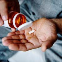 Taking pain medication during recovery from dental implant surgery