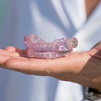 Hand holding oral appliance