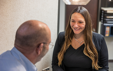Oral surgery team member smiling at a patient