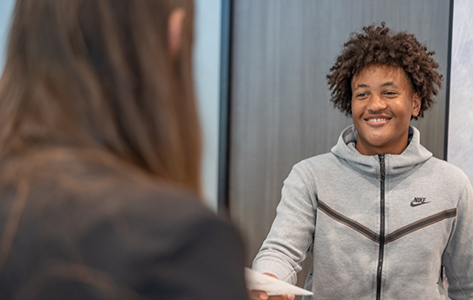 Young man checking in at front desk