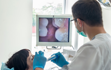 Dentist taking close up photos of a patient's teeth