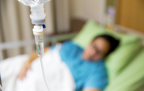 Patient in a bed connected to an IV