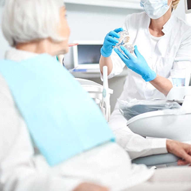 Senior woman learning about her candidacy for All-on-4 treatment