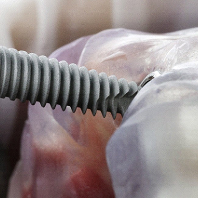 Close-up of dental implant being inserted into model