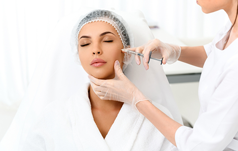 Woman getting a BOTOX injection in her cheek