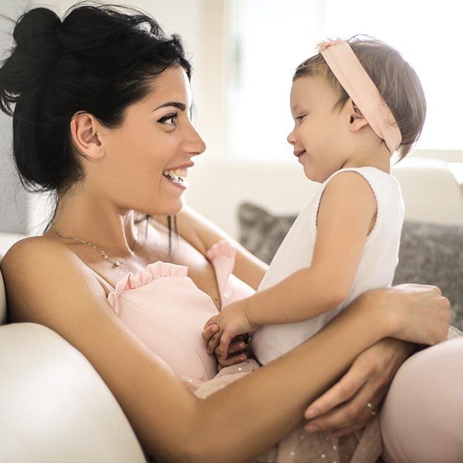 Mother and infant laughing together