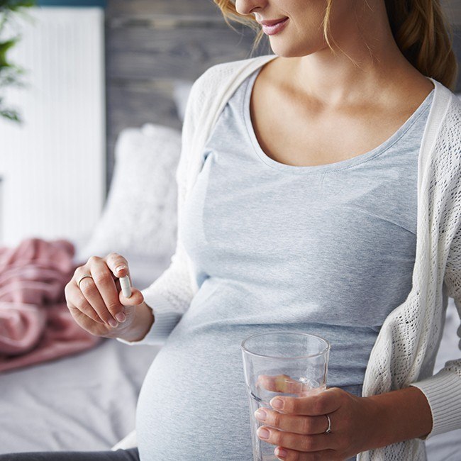 Pregnant woman taking folic acid