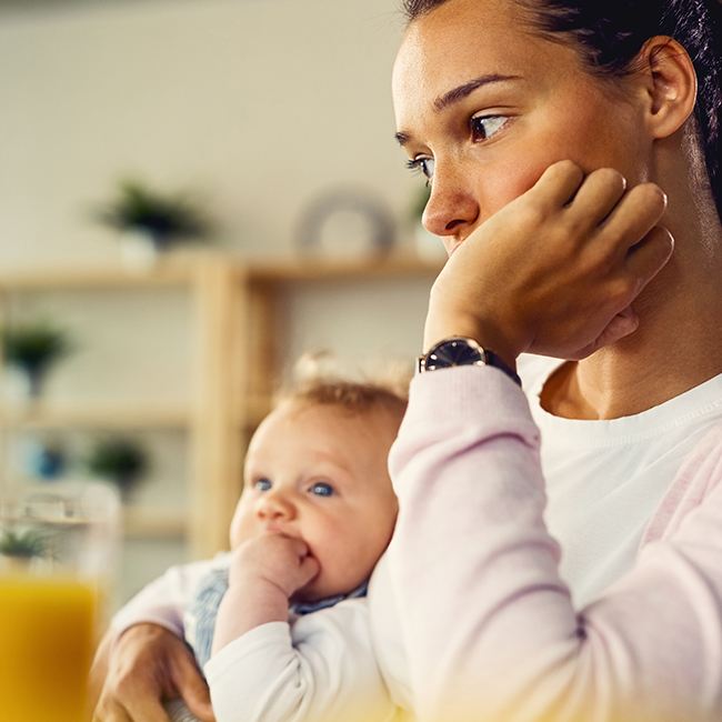 Mother holding her infant child who has a cleft