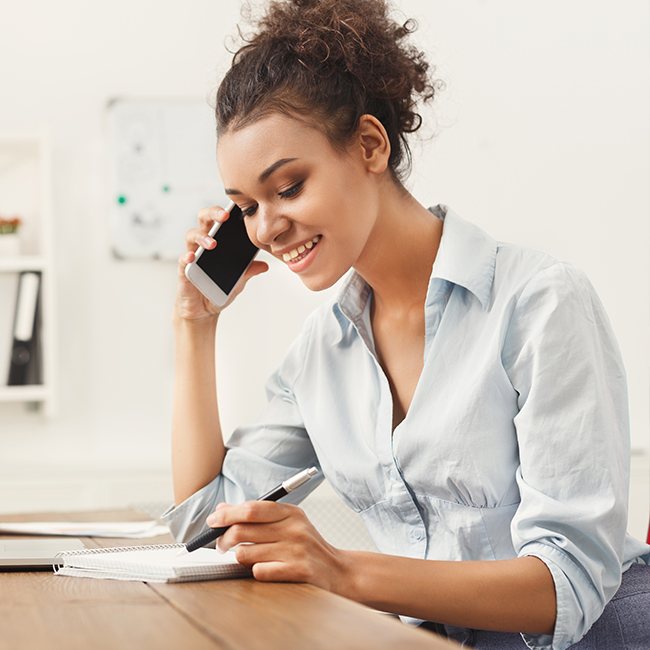 Woman on phone scheduling consultation