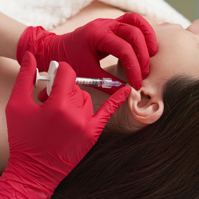 Patient receiving earlobe repair treatment