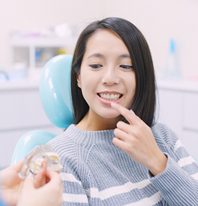 Patient pointing to her teeth