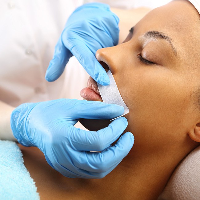 Oral surgeon treating soft tissue facial injury