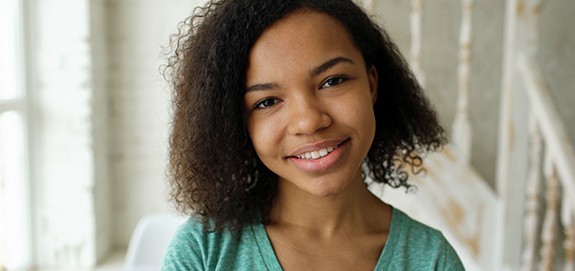 Young woman smiling after corrective orthodontic surgery