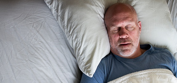 Man sleeping soundly after sleep apnea therapy