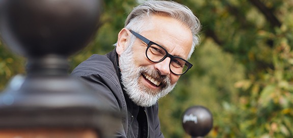 Older man smiling after oral cancer screening