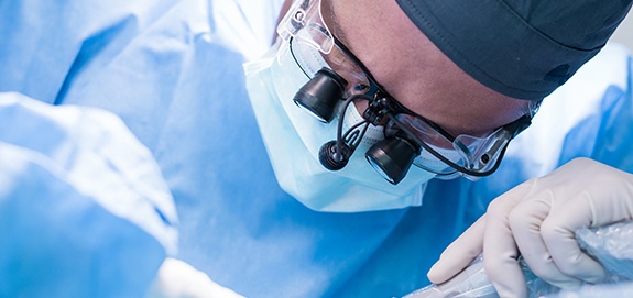 Oral surgeon performing pre-prosthetic surgery