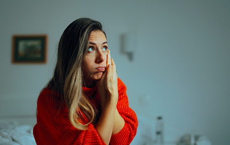 Woman holding the side of her face in pain