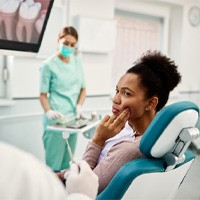 Patient with toothache talking to dentist