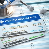 Dental and health insurance cards next to stethoscope