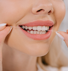 Person flossing their teeth