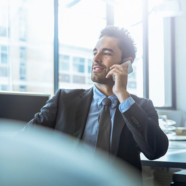 Man at work on phone after surgery for facial injury