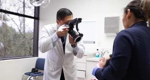 Houston oral surgeon taking a photo of a patient's mouth