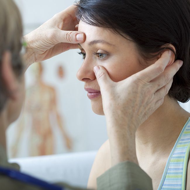 Oral surgeon examining patient's sinuses