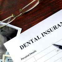 Dental insurance form next to money and X-Ray