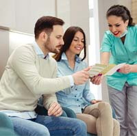 Couple learning about payment options for dental implants