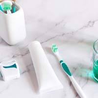 Oral hygiene tools laid out on marble countertop