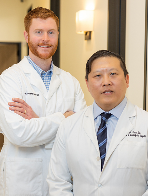 Two smiling Houston oral surgeons