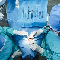 Oral surgeons performing surgery preparation