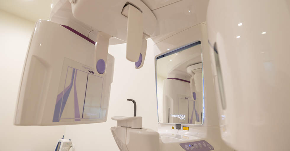 Cone beam C T scanning machine standing against a wall