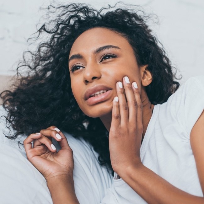 Woman in pain before wisdom tooth extraction