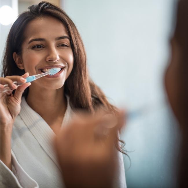 Woman brushing teeth