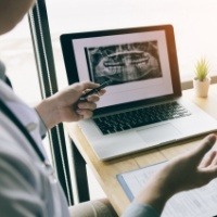 Oral surgeon and patient reviewing treatment details