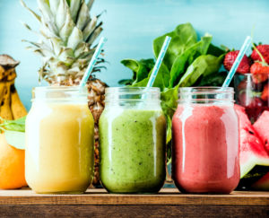 fresh blended fruit smoothies in glass jars