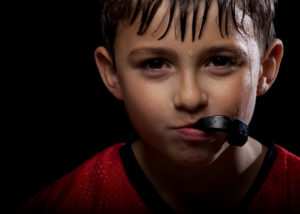 Young boy wearing sports mouth guard