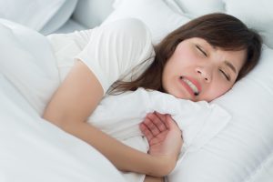 woman grinding her teeth at night