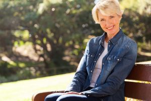 senior woman sitting on a bench outdoors