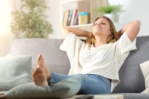 woman relaxing, following instructions from oral surgeon in Houston after extraction