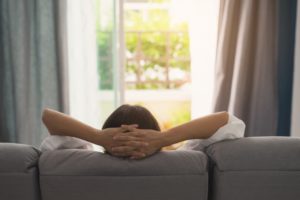 Woman relaxing at home during wisdom tooth recovery