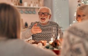 Man enjoying dinner with family after oral surgery