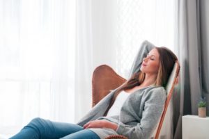 Woman relaxing at home after dental implant surgery