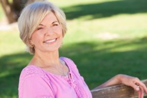 Smiling older woman enjoying the longevity of her dental implants