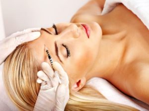 Blond woman relaxing while receiving BOTOX® injection