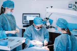 Oral surgery team carefully working on patient