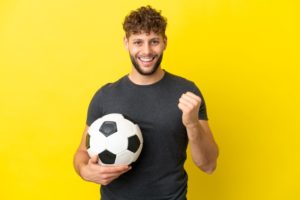 Smiling man holding soccer ball