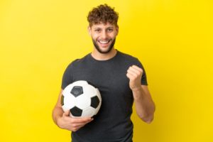 Smiling man holding soccer ball