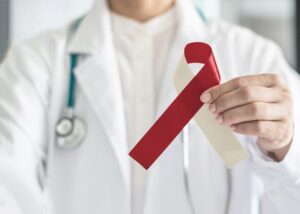 Medical professional holding oral cancer ribbon